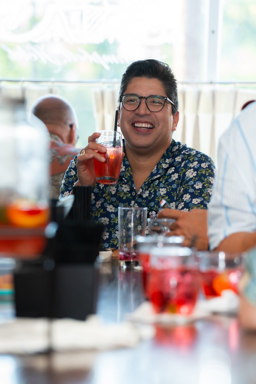 Guest laughing with a cocktail
