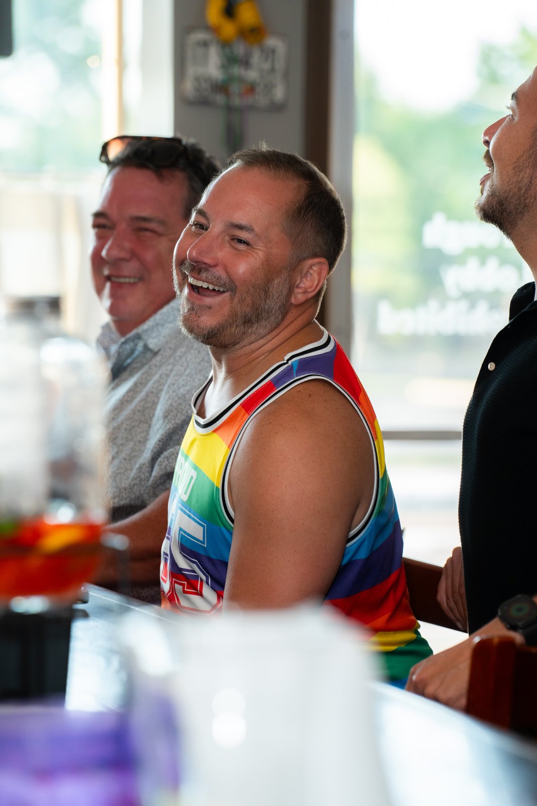 Guests in pride colors laughing